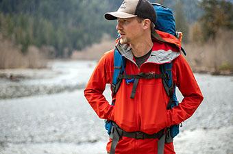 Walking next to the water on a backpacking trip while wearing the Arc'teryx Gamma LT Hoody